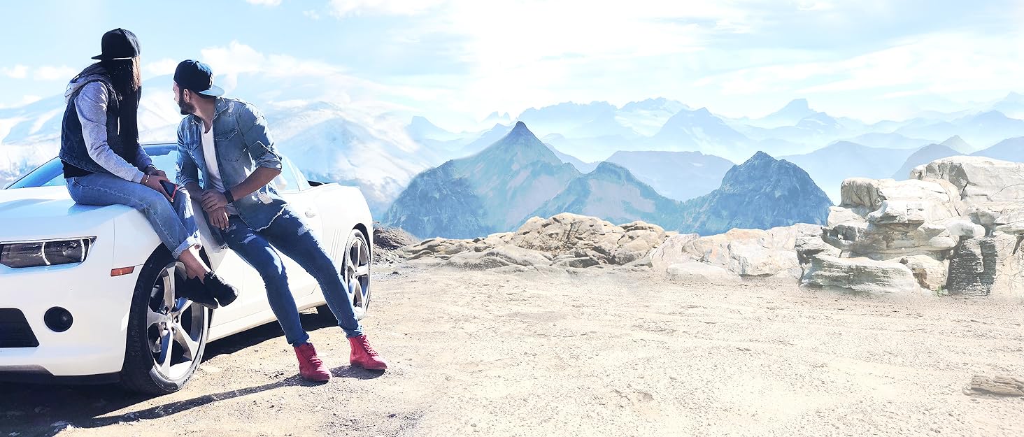 couple leaning on car, view of the mountains. car accessories