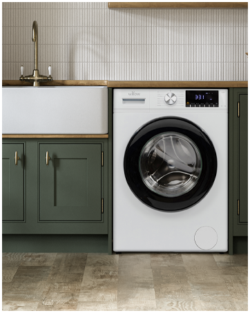 Willow 8kg washing machine in green kitchen next to a white sink