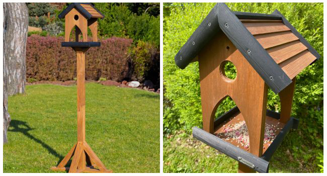 wooden bird table with charcoal roof in garden