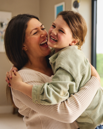 A mother and daughter hug.