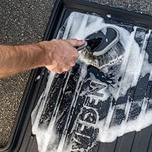 DRIVEDEN Boot Mat being cleaned with a soft brush and soapy water