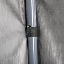 Close-up view of a gray tarp or covering material with visible seam and fastener in center, showing textured surface pattern.