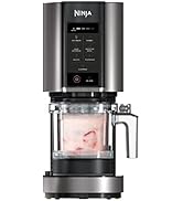 Compact frozen drink machine with sleek black and silver design, featuring red accent details and a dispensing spout positioned over a cocktail glass.