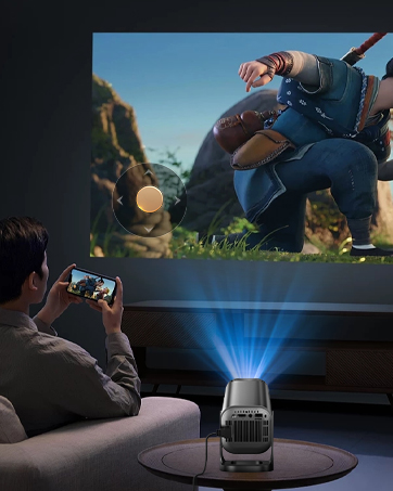 Portable projector device shown in use, displaying blue projection beam on dark surface. Multiple angles demonstrate compact size and projection capabilities.