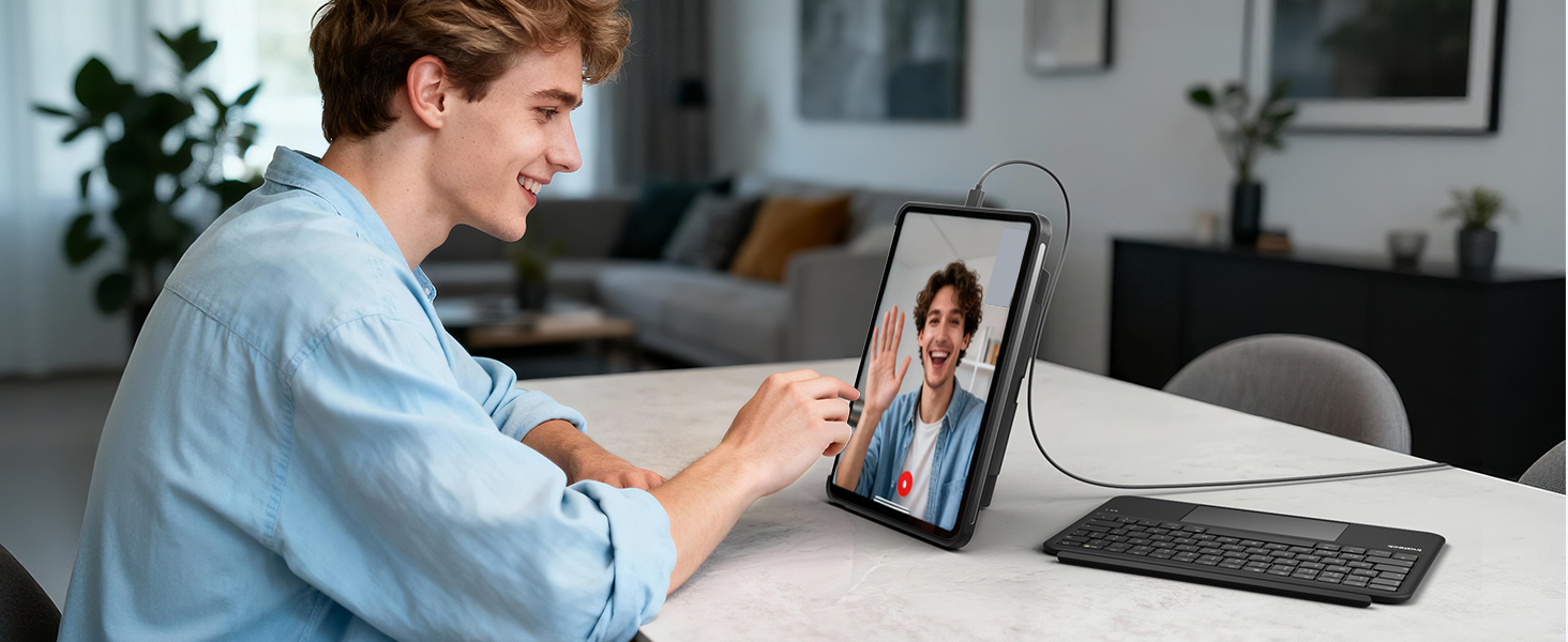 Person using a tablet device in horizontal orientation, supported by a stand while engaging in a video call or virtual meeting.