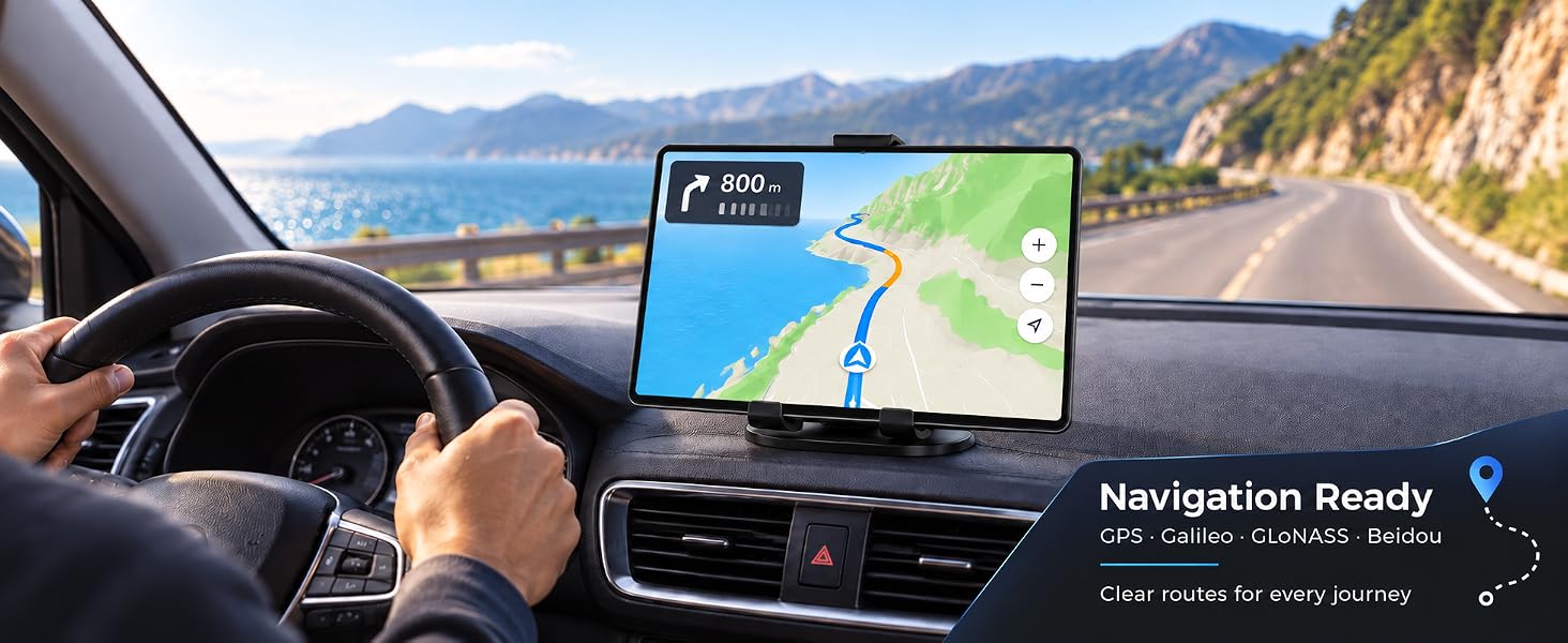 Text reads 'Navigation Ready.' Car dashboard displaying GPS navigation map on digital screen, photographed from driver's perspective with coastal mountain road visible through windshield.