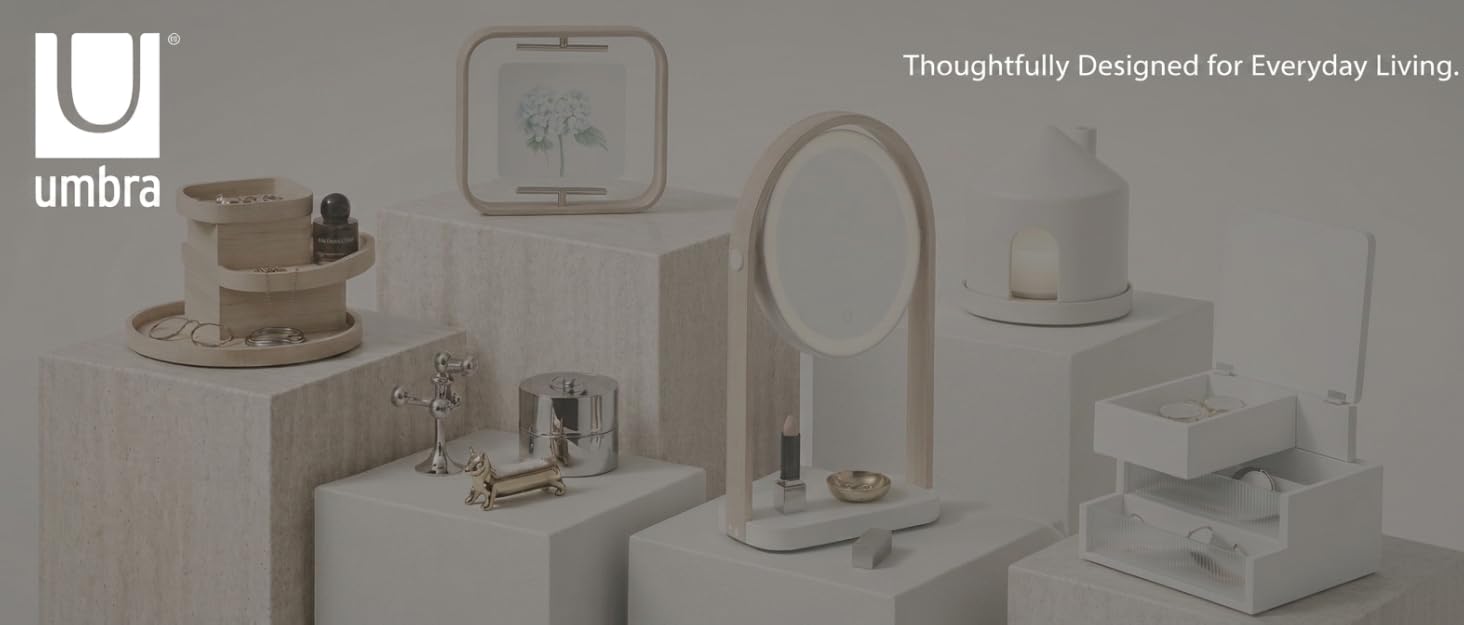 Text reads 'Umbra' and 'Thoughtfully Designed for Everyday Living.' Gray-toned product collection display showing home organization and bathroom accessories.